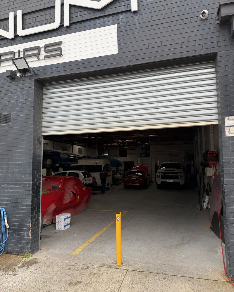 Yellow Key Bollard installed outside a Melbourne panel shop entrance, keyed to the business owner